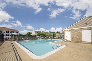Outdoor pool area with fenced deck and lounge chairs